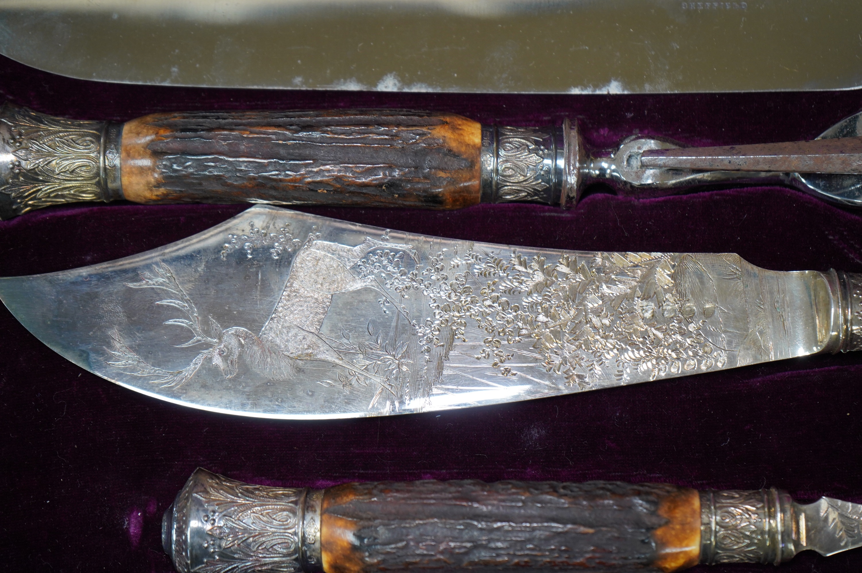 A gilt tooled leather cased stag handled silver collared carving set, case 44cm wide. Condition - good
